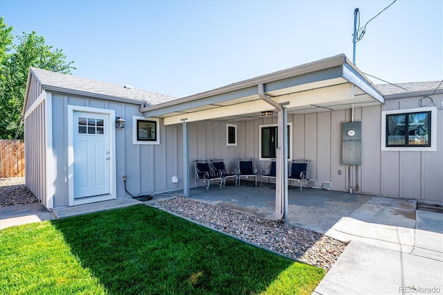 3995 Nelson St, Wheat Ridge, CO 80033 - back of property featuring board and batten siding, a patio area, an outdoor living space, a lawn, and a shingled roof