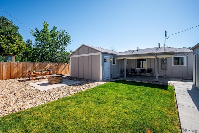 3995 Nelson St, Wheat Ridge, CO 80033 - back of property featuring board and batten siding, a patio area, and an outdoor living space with a fire pit