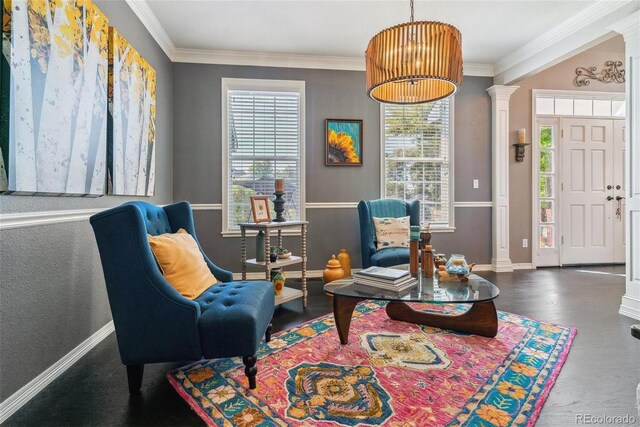 living area with ornamental molding, ornate columns, and an inviting chandelier