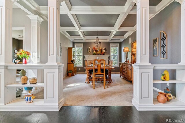 dining area featuring plenty of natural light, coffered ceiling, and decorative columns