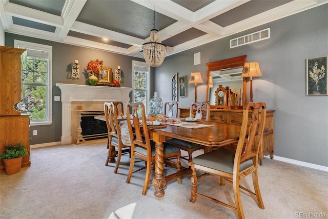 dining area featuring coffered ceiling, light colored carpet, a wealth of natural light, and a tiled fireplace