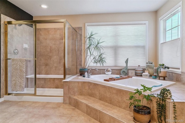 bathroom with independent shower and bath and tile patterned floors