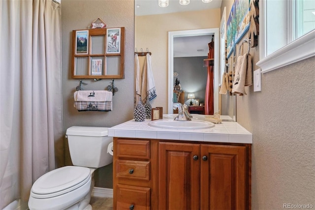 bathroom featuring toilet and vanity