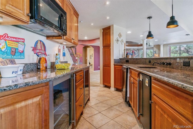 kitchen featuring dark stone countertops, decorative light fixtures, black appliances, wine cooler, and a textured ceiling