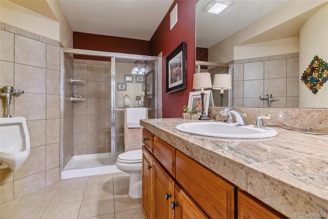 bathroom with tile patterned flooring, toilet, a shower with door, and vanity