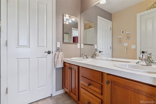 bathroom with tile patterned flooring and vanity