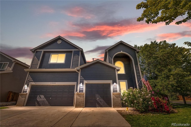 11545 E 119th Ave, Commerce City, CO 80640 - view of front of house featuring concrete driveway, a garage, and brick siding