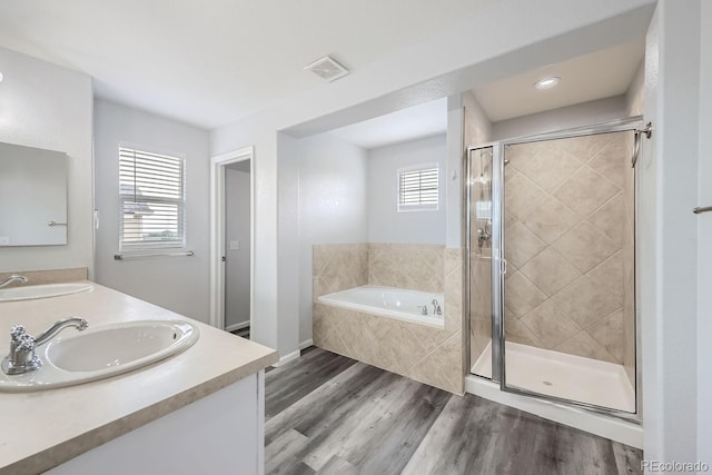 bathroom with independent shower and bath, vanity, and wood-type flooring