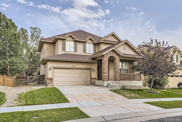 view of front of property featuring a garage, covered porch, and a front lawn