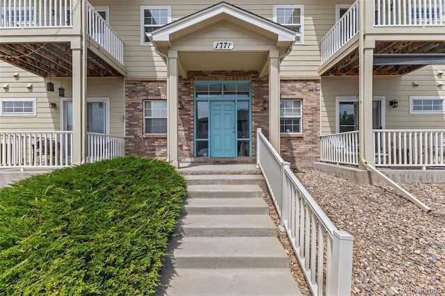 property entrance with brick siding