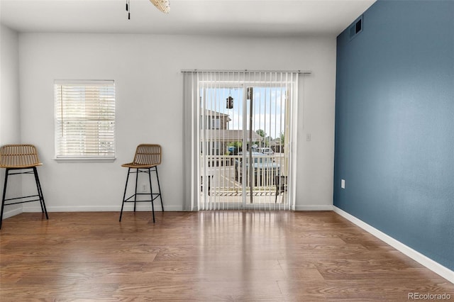 unfurnished room featuring wood finished floors and baseboards