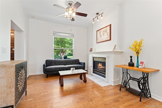 2829 N Franklin St, Denver, CO 80205 - living area with a ceiling fan, wood finished floors, and a fireplace with flush hearth