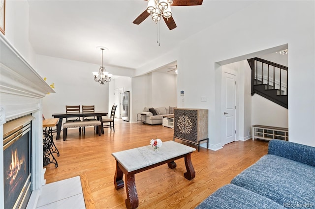 2829 N Franklin St, Denver, CO 80205 - living room with ceiling fan, stairway, a warm lit fireplace, and wood finished floors