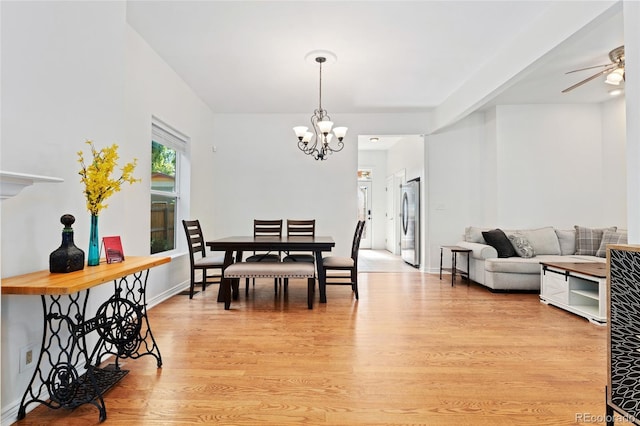 2829 N Franklin St, Denver, CO 80205 - dining area featuring light wood finished floors, a chandelier, and ceiling fan