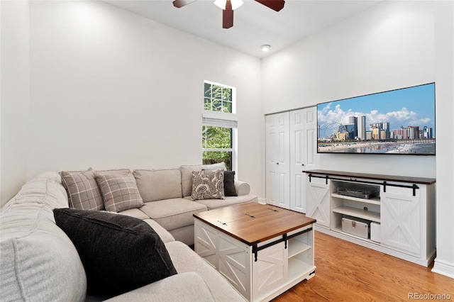 2829 N Franklin St, Denver, CO 80205 - living room with a ceiling fan, a high ceiling, and light wood-style flooring