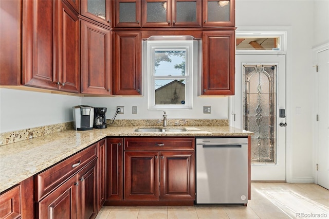 2829 N Franklin St, Denver, CO 80205 - kitchen featuring stainless steel dishwasher, reddish brown cabinets, light stone countertops, light tile patterned floors, and glass insert cabinets