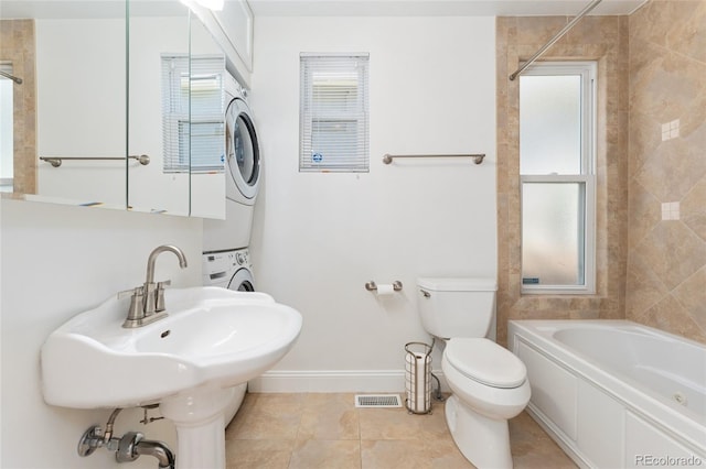 2829 N Franklin St, Denver, CO 80205 - full bath featuring stacked washing machine and dryer, a whirlpool tub, tile patterned flooring, and a shower