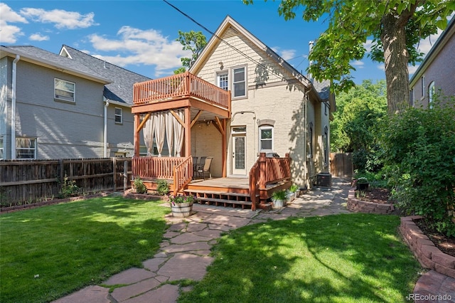 2829 N Franklin St, Denver, CO 80205 - back of property with a fenced backyard, brick siding, a wooden deck, and a balcony
