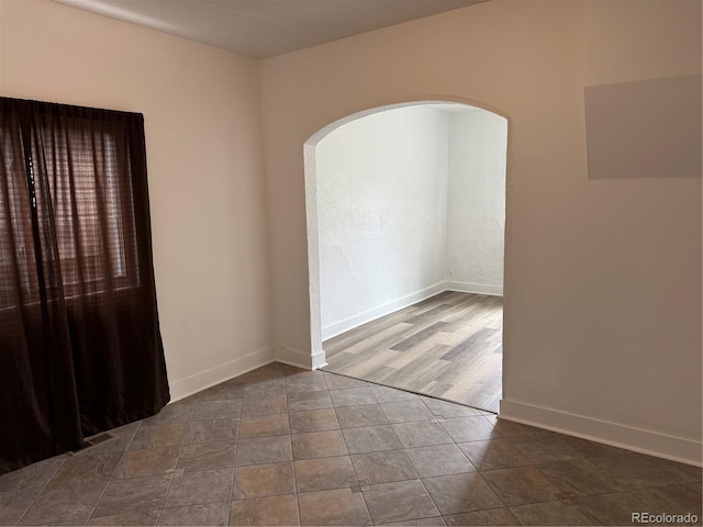 4807 Clayton St, Denver, CO 80216 - unfurnished room with arched walkways and baseboards