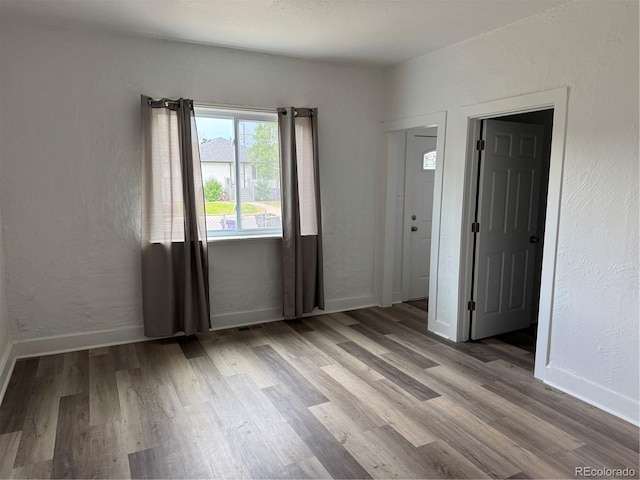 4807 Clayton St, Denver, CO 80216 - empty room featuring wood finished floors and a textured wall