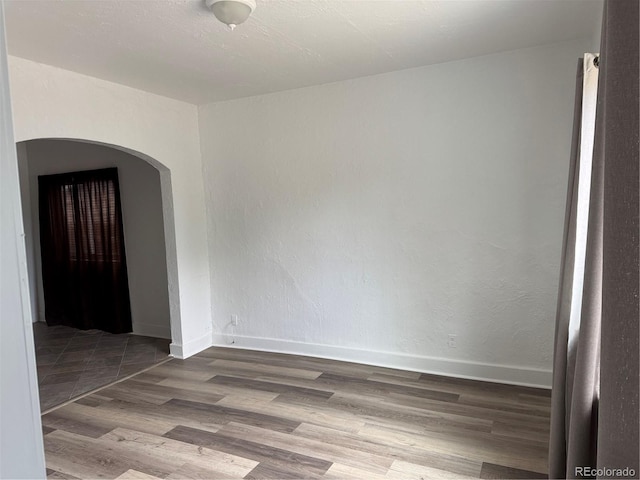 4807 Clayton St, Denver, CO 80216 - spare room with arched walkways and wood finished floors