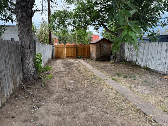 4807 Clayton St, Denver, CO 80216 - fenced backyard featuring a storage unit