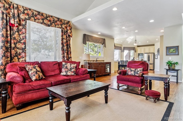 living room featuring wine cooler, recessed lighting, light wood-type flooring, and baseboards