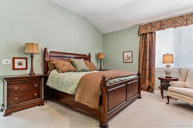 bedroom featuring light colored carpet and vaulted ceiling