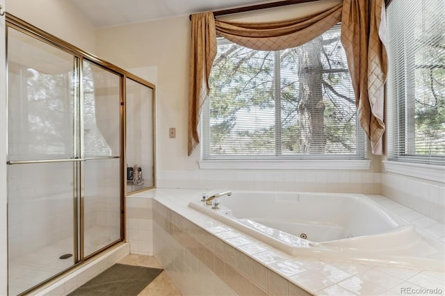 bathroom featuring a shower stall, tile patterned floors, and a whirlpool tub