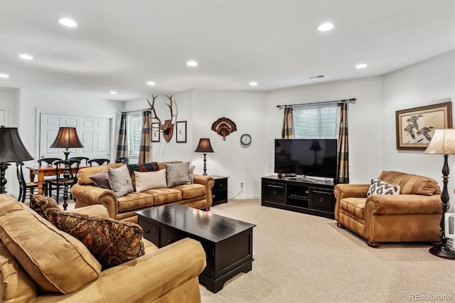 living room with recessed lighting, visible vents, light carpet, and baseboards