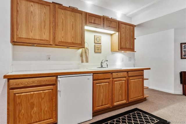 kitchen with a sink, fridge, carpet flooring, light countertops, and dishwasher