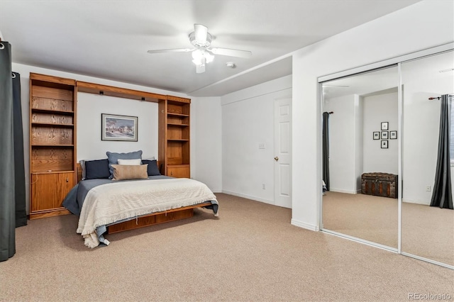 bedroom with a closet, baseboards, a ceiling fan, and carpet flooring