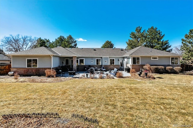 rear view of house with a patio area and a lawn