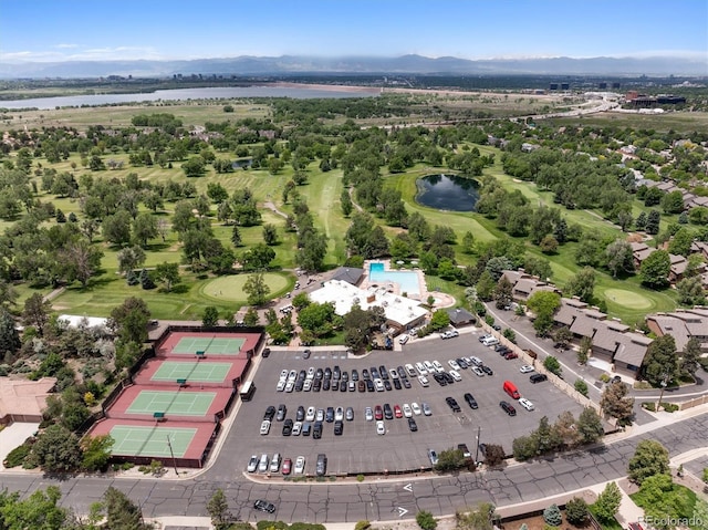 aerial view with golf course view and a water view