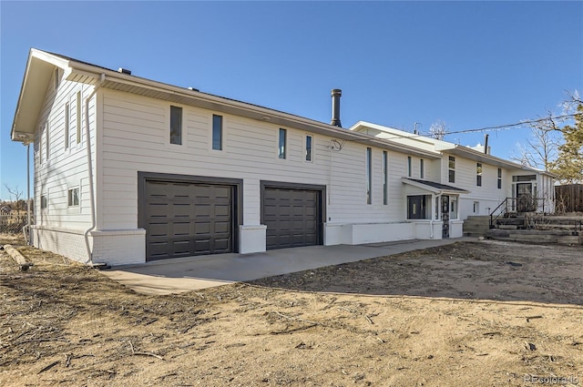 rear view of house with a garage