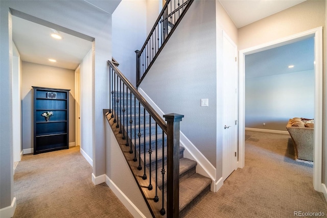 stairway featuring carpet flooring