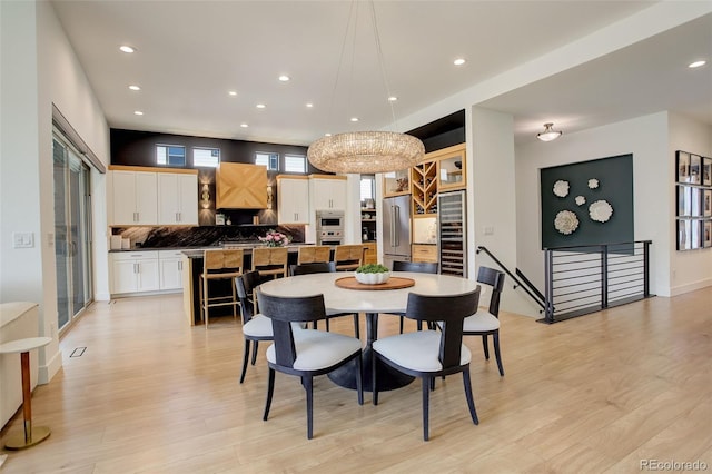 3436 W 154th Ave, Broomfield, CO 80023 - dining room featuring beverage cooler, light wood-style flooring, and recessed lighting
