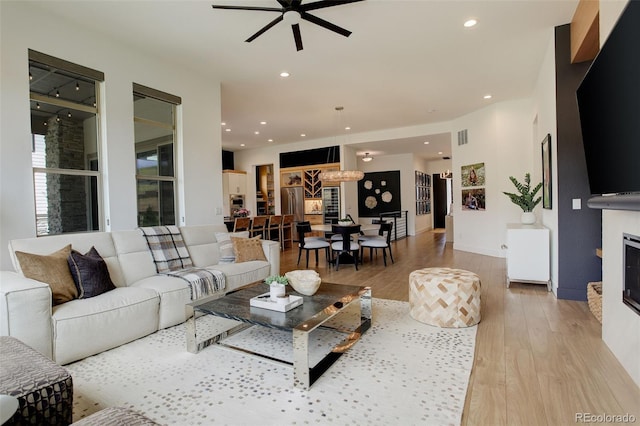 3436 W 154th Ave, Broomfield, CO 80023 - living area featuring ceiling fan, light wood-type flooring, recessed lighting, and a fireplace