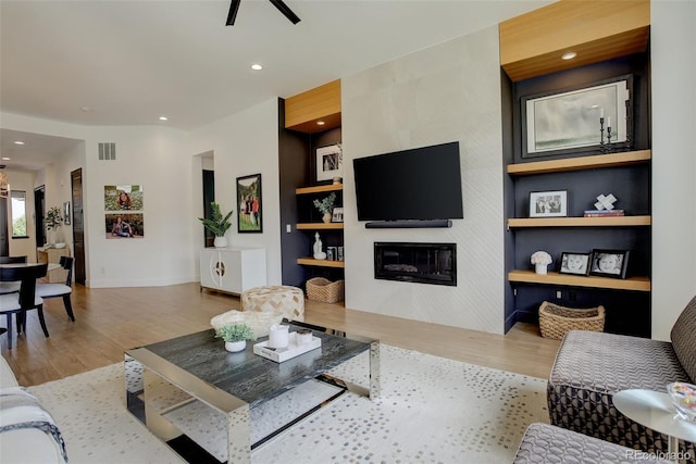 3436 W 154th Ave, Broomfield, CO 80023 - living room with wood finished floors, a fireplace, ceiling fan, recessed lighting, and built in features