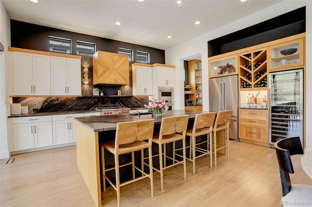 3436 W 154th Ave, Broomfield, CO 80023 - kitchen with high end refrigerator, beverage cooler, recessed lighting, a kitchen island with sink, and tasteful backsplash