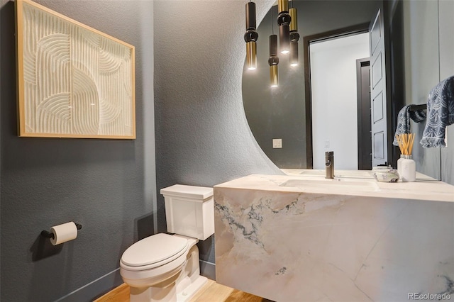 3436 W 154th Ave, Broomfield, CO 80023 - bathroom featuring a textured wall, vanity, and wood finished floors
