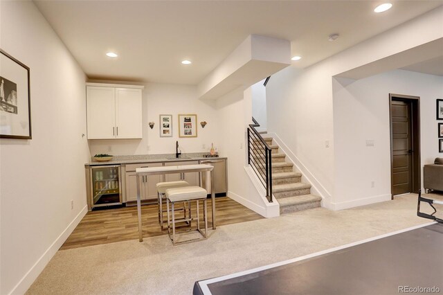 3436 W 154th Ave, Broomfield, CO 80023 - kitchen with wine cooler, light colored carpet, recessed lighting, dishwasher, and white cabinets