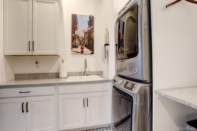 3436 W 154th Ave, Broomfield, CO 80023 - laundry room featuring stacked washing machine and dryer and cabinet space