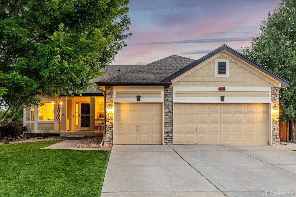 20805 Omaha Ave, Parker, CO 80138 - view of front of property with stone siding, concrete driveway, a garage, a front lawn, and roof with shingles