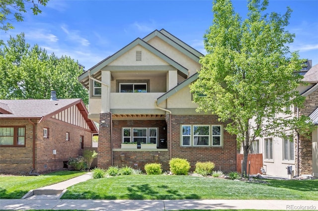 449 S Humboldt St, Denver, CO 80209 - view of front of house with stucco siding, a front yard, and brick siding