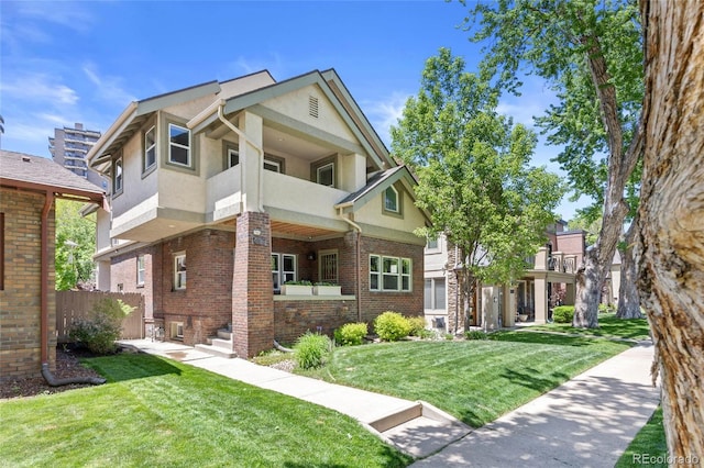 449 S Humboldt St, Denver, CO 80209 - view of front facade featuring stucco siding, a balcony, and brick siding
