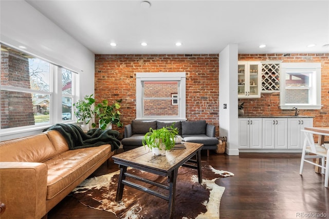 449 S Humboldt St, Denver, CO 80209 - living area featuring brick wall, dark wood-type flooring, and recessed lighting