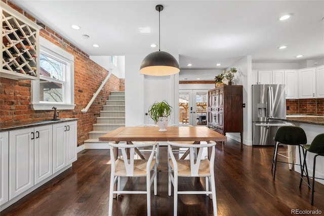 449 S Humboldt St, Denver, CO 80209 - dining space featuring brick wall, dark wood finished floors, french doors, stairs, and recessed lighting