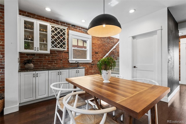 449 S Humboldt St, Denver, CO 80209 - dining area with dark wood finished floors and brick wall