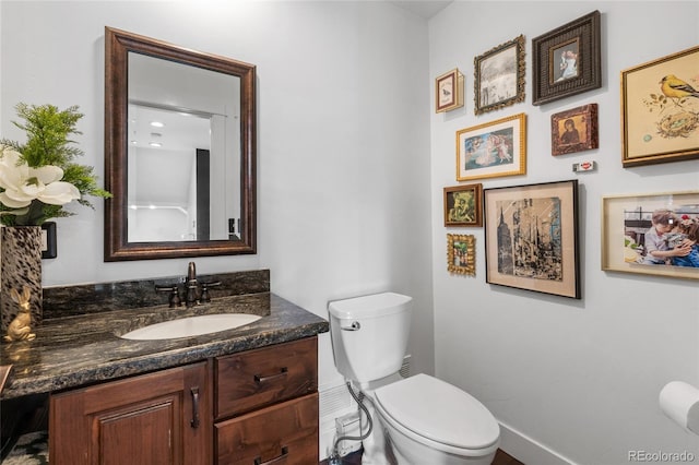 449 S Humboldt St, Denver, CO 80209 - half bath with baseboards, toilet, and vanity